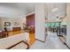 Open-concept living space with hardwood floors, piano, and view to dining room at 8944 W 66Th Pl, Arvada, CO 80004