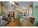 View of living space with kitchen, dining, and entryway, showcasing open floor plan at 8944 W 66Th Pl, Arvada, CO 80004