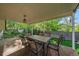 Covered patio boasts ample seating, perfect for outdoor dining and relaxation in a serene setting at 8944 W 66Th Pl, Arvada, CO 80004