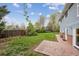 Large backyard with grass and patio area with hammock strung between the trees at 4634 S Adobe Ct, Littleton, CO 80127