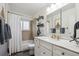 Bright bathroom featuring a double sink vanity, tile shower, and modern fixtures, providing a clean and functional space at 4634 S Adobe Ct, Littleton, CO 80127
