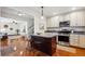 Open concept kitchen with stainless steel appliances, granite countertops, and a center island with breakfast bar at 4634 S Adobe Ct, Littleton, CO 80127
