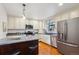 Modern kitchen features stainless steel appliances, granite countertops, and white cabinetry, offering both style and functionality at 4634 S Adobe Ct, Littleton, CO 80127