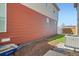 Side yard view with two-tone siding, small strip of grass, and an A/C unit at 5035 N Walden Way, Denver, CO 80249