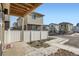 Backyard patio and fenced yard with view of neighboring houses at 5035 N Walden Way, Denver, CO 80249