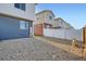 Backyard area of home with white fencing and minimal grass at 5035 N Walden Way, Denver, CO 80249