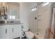 Bright bathroom with a modern vanity, mirror, and walk-in shower featuring built-in shelving at 5035 N Walden Way, Denver, CO 80249