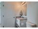 Compact, clean bathroom features modern vanity, mirror, and a toilet at 5035 N Walden Way, Denver, CO 80249