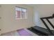 Clean bedroom with neutral carpet featuring a window and modern exercise equipment at 5035 N Walden Way, Denver, CO 80249