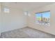 Bright, carpeted bedroom with large window offering lots of natural light at 5035 N Walden Way, Denver, CO 80249