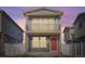 Charming two-story home with a balcony and a red front door under a beautiful sky at 5035 N Walden Way, Denver, CO 80249