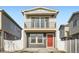 Two-story home with a small front-facing balcony and a vibrant red front door at 5035 N Walden Way, Denver, CO 80249
