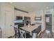 Modern kitchen features stainless steel appliances, white cabinetry, and an island with seating at 5035 N Walden Way, Denver, CO 80249