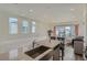 Modern kitchen featuring island with seating, stainless steel appliances, and open layout at 5035 N Walden Way, Denver, CO 80249
