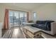 Cozy living room features comfortable sectional sofa and a balcony with neighborhood views at 5035 N Walden Way, Denver, CO 80249