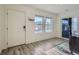 Bright living room with hardwood floors, large windows, and a sliding door for ample natural light at 5035 N Walden Way, Denver, CO 80249