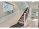 Carpeted staircase with window and modern handrail design at 5035 N Walden Way, Denver, CO 80249