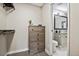 Walk-in closet with adjacent bathroom featuring granite counters and modern fixtures at 7755 E Quincy # 201, Denver, CO 80237