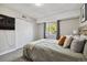 Cozy bedroom with carpet floors, large window, and built-in closet at 7755 E Quincy # 201, Denver, CO 80237