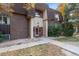 A close exterior view of a two-story apartment building with brick facade, mature landscaping, and building A2 entrance at 7755 E Quincy # 201, Denver, CO 80237