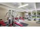 Well-equipped gym area with various exercise machines, including treadmill, weights, and elliptical machines at 7755 E Quincy # 201, Denver, CO 80237
