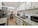 Contemporary kitchen design with sleek countertops, stainless steel, and an adjacent dining area at 7755 E Quincy # 201, Denver, CO 80237