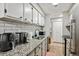 Well-equipped kitchen with stainless steel appliances and sleek white cabinetry at 7755 E Quincy # 201, Denver, CO 80237
