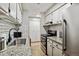 Updated kitchen features white subway tile backsplash and modern appliances at 7755 E Quincy # 201, Denver, CO 80237