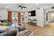 Bright and airy living room featuring hardwood floors and a sliding glass door to the balcony at 7755 E Quincy # 201, Denver, CO 80237