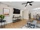 Modern living room open to kitchen and dining area with recessed lighting and hardwood floors at 7755 E Quincy # 201, Denver, CO 80237
