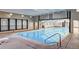 Indoor pool area featuring a lap pool, seating, and natural light at 7755 E Quincy # 201, Denver, CO 80237