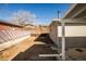 Spacious backyard featuring a retaining wall and access to the home's covered patio at 4933 W 61St Ave, Arvada, CO 80003