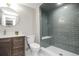 Stylish bathroom with modern vanity and walk-in shower with bench seat at 4933 W 61St Ave, Arvada, CO 80003