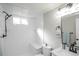 Bright, tiled bathroom features a shower with a built-in bench and a sleek vanity at 4933 W 61St Ave, Arvada, CO 80003