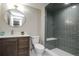 Modern bathroom features elegant vanity and walk-in shower with bench seat at 4933 W 61St Ave, Arvada, CO 80003