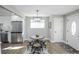 Bright dining area featuring stylish modern furniture, natural light, and easy access to the kitchen at 4933 W 61St Ave, Arvada, CO 80003