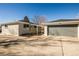 Exterior view of the home and the detached garage from the driveway at 4933 W 61St Ave, Arvada, CO 80003