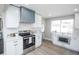 Modern kitchen featuring stainless steel appliances, updated white cabinetry, and a well-lit workspace at 4933 W 61St Ave, Arvada, CO 80003