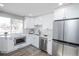 Bright modern kitchen with stainless steel appliances, quartz counters, and easy access to the dining area at 4933 W 61St Ave, Arvada, CO 80003