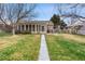 Landscaped backyard with a concrete pathway and enclosed porch, ideal for outdoor enjoyment at 3021 Locust St, Denver, CO 80207