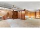 Spacious basement featuring carpet, wood paneling, drop ceiling and access to the upper floors at 3021 Locust St, Denver, CO 80207