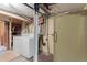 Utility basement with laundry area featuring a washing machine and dryer hookups at 3021 Locust St, Denver, CO 80207