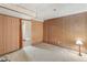 Basement bedroom featuring wood paneling, carpet, closet, and an adjacent bathroom at 3021 Locust St, Denver, CO 80207