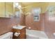 Full bathroom with tile, bathtub, and sink, offering comfort and functionality at 3021 Locust St, Denver, CO 80207