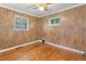 Bedroom featuring hardwood floors, ceiling fan, and windows providing natural light at 3021 Locust St, Denver, CO 80207