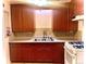 Traditional kitchen featuring wood cabinets, tile backsplash, and stainless steel sink at 3021 Locust St, Denver, CO 80207