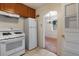 Kitchen with a range, refrigerator, and a doorway that leads to a carpeted dining room at 3021 Locust St, Denver, CO 80207
