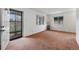 Bright living room with neutral walls, windows, and carpet providing a clean and cozy space at 3021 Locust St, Denver, CO 80207
