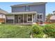 Backyard view of the home features a patio with chairs, a fire pit, and grass area at 11569 Grape St, Thornton, CO 80233