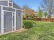 Landscaped backyard featuring a lush lawn, wooden fence, and a charming storage shed at 11569 Grape St, Thornton, CO 80233